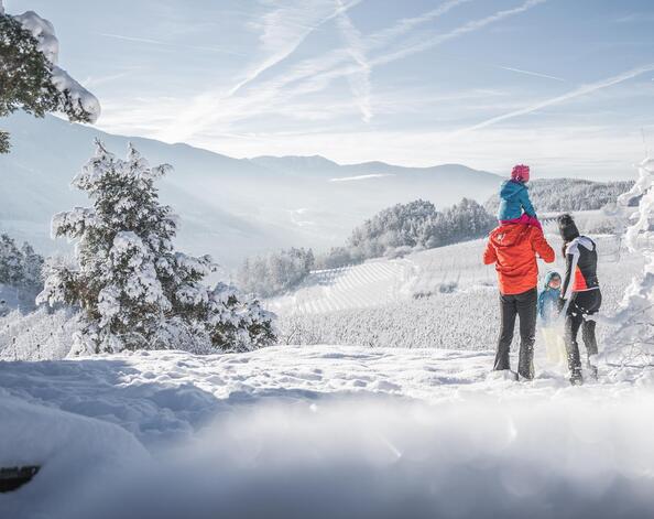 A family is hiking in the snow