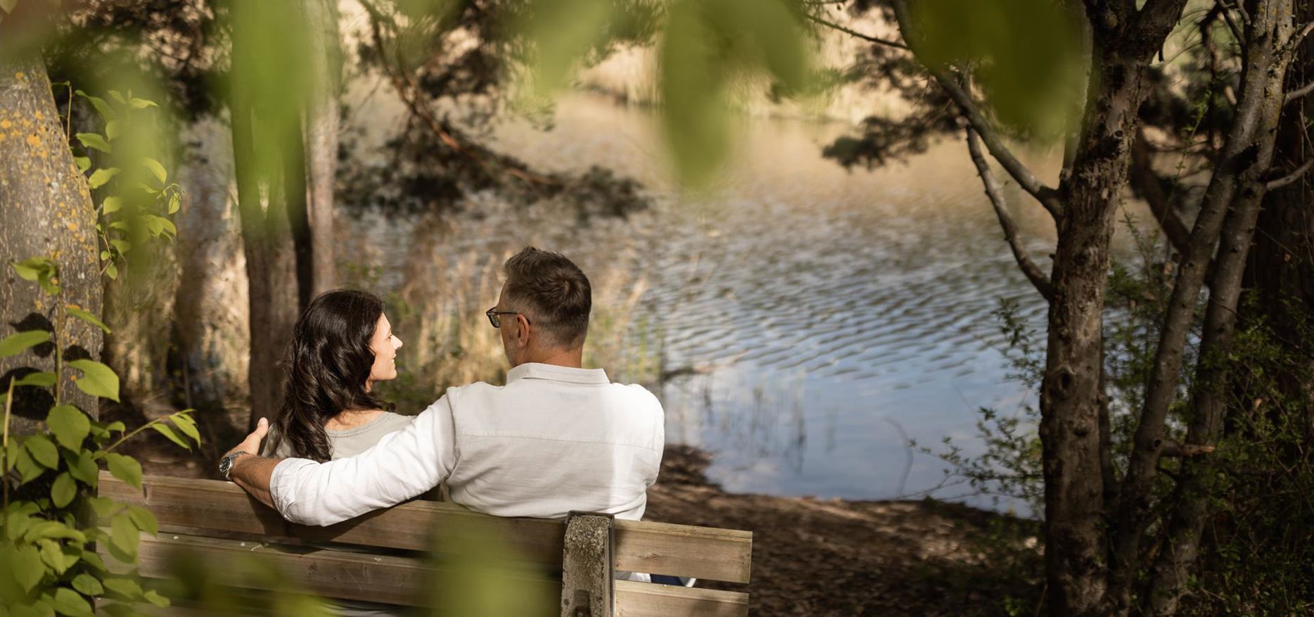 A man and a woman walk along the apple trail