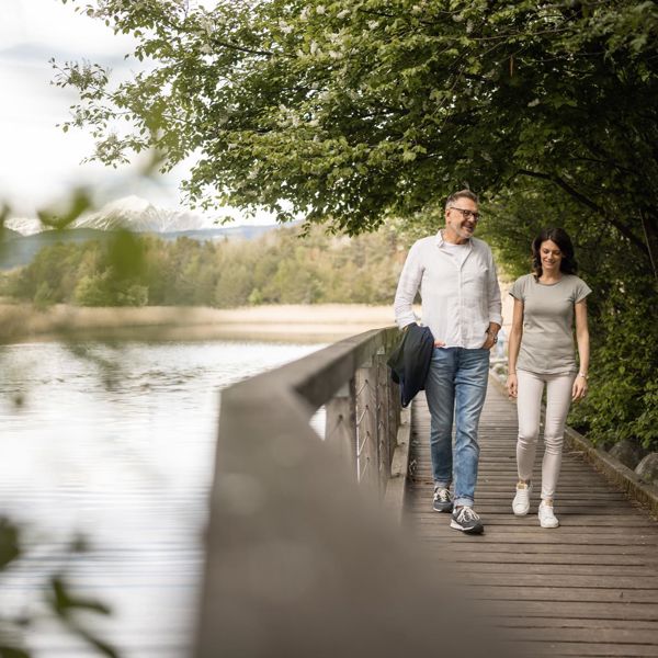 A man and a woman walk along the apple trail