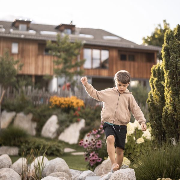 A child is balancing on stones